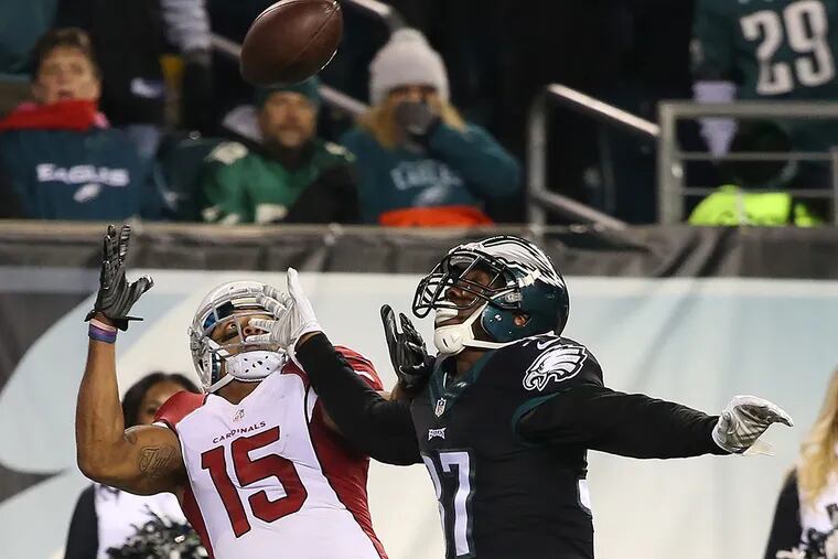 Cardinals receiver Michael Floyd makes a one-handed catch over Malcolm Jenkins.