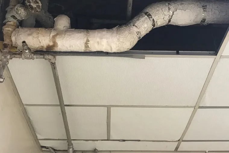 Damaged asbestos was discovered in the T.M. Peirce Elementary School gym. A water leak damaged the asbestos insulation on a pipe seen here above a bulletin board in the gym. This photo was taken in mid-September.