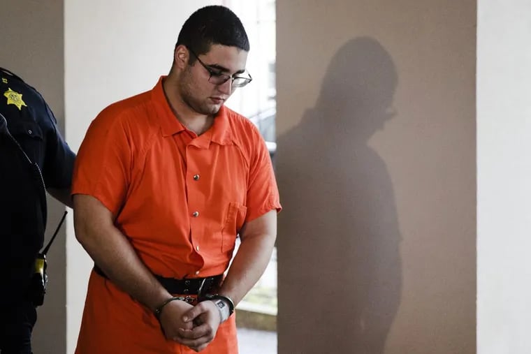 A law enforcement official escorts Cosmo DiNardo to a vehicle Thursday, July 13, 2017, in Doylestown, Pa. Lawyer Paul Lang, a defense attorney for DiNardo, said Thursday that his client has admitted killing the four men who went missing last week and told authorities the location of the bodies. Lang says prosecutors agreed to take the death penalty off the table in return for DiNardo's cooperation.