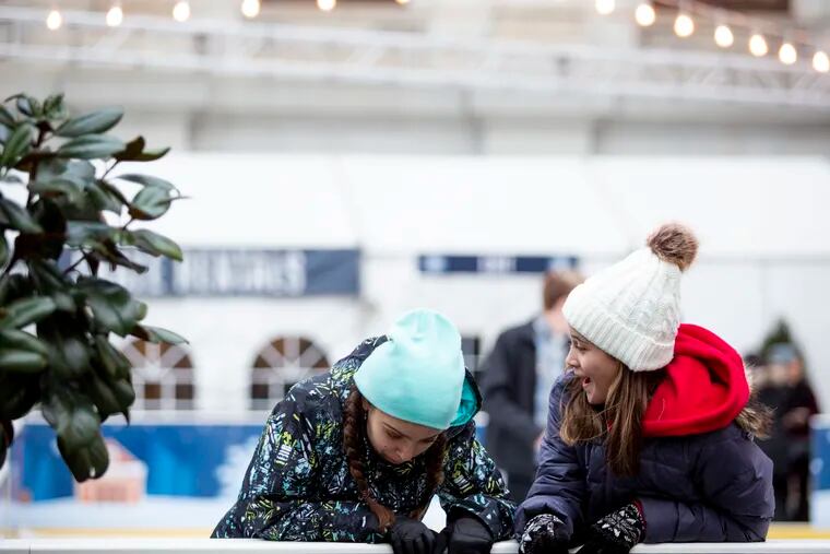 Calise Wanko, 13, (left) and Sydney Smallwood, 11, (right) ice skate at Rothman Institute Ice Rink in Dillworth Plaza on Thursday, Dec. 6, 2018.