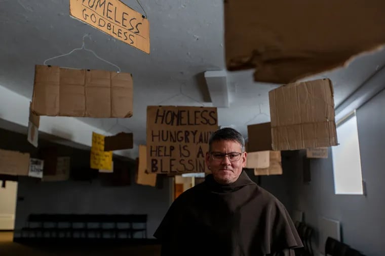 Monsignor James St. George stands in Saint Miriam Parish and Friary in an exhibit by Willie Baronet entitled "We Are All Homeless" in Flourtown, PA, Thursday, March 7, 2019. Father Jim has focused his attention on homelessness in 2019 and hopes the exhibit will inspire people to give outwardly rather than giving up items or foods during Lent.