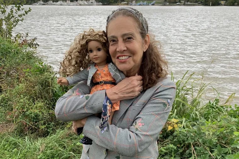 Sharon Dennis Wyeth, 73, and Evette, the American Girl doll whose story she wrote, posing in front of the Anacostia River, which is part of the dollâ€™s backstory and Wyethâ€™s childhood in D.C.