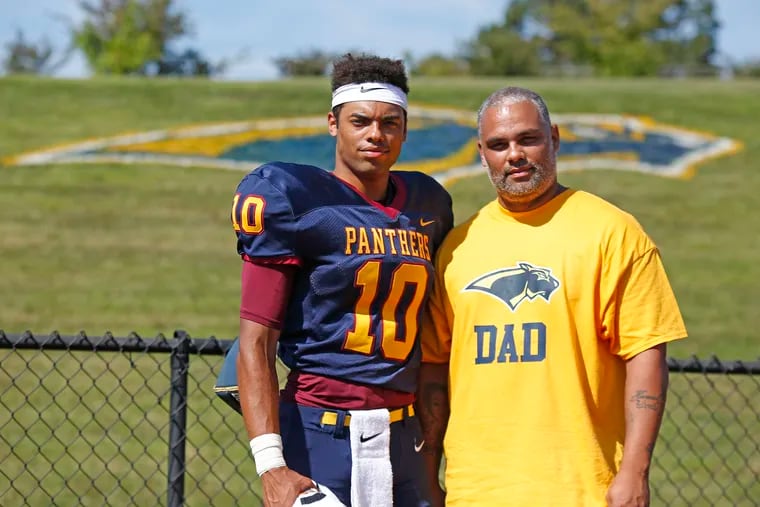 Pope John Paul II quarterback Kamal Gray (10) with his dad, Kamal Gray, keyboard player for famed musical group The Roots, after a non-league football game against New Hope-Solebury Aug. 31 in Royersford. The host Golden Panthers won, 55-6.