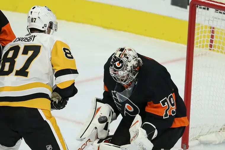Flyers' goalie Carter Hart stops a shot from the Penguins' Sidney Crosby on Jan. 15. Crosby missed the Penguins' 5-2 win over the Flyers Tuesday.