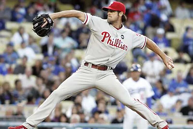 Cole Hamels' complete game helped the Phillies get their 20th road win of the season. (Lori Shepler/AP)