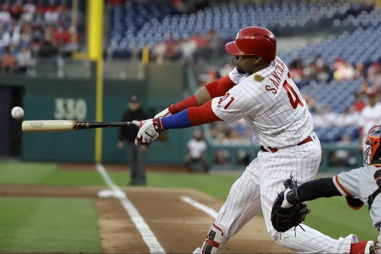 Phillies first baseman Carlos Santana hits an RBI-double off San Francisco starting pitcher Chris Stratton during the first inning of the Phillies’ win on Wednesday.