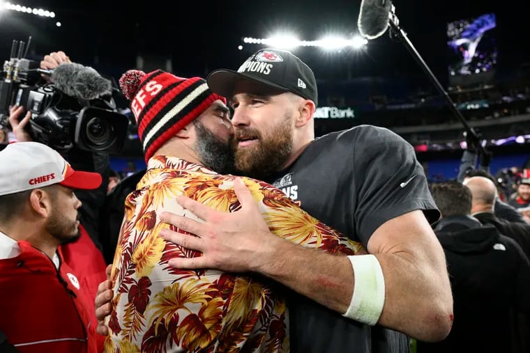 Eagles center Jason Kelce embraces his brother Travis after the tight end and the Kansas City Chiefs won the AFC championship Sunday in Baltimore.