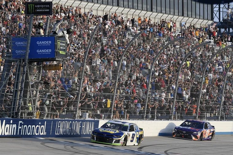 Chase Elliott (9) takes the checkered flag in front of Denny Hamlin (11) to win a NASCAR Cup Series auto race, Sunday, Oct. 7, 2018, at Dover International Speedway in Dover, Del. (AP Photo/Nick Wass)