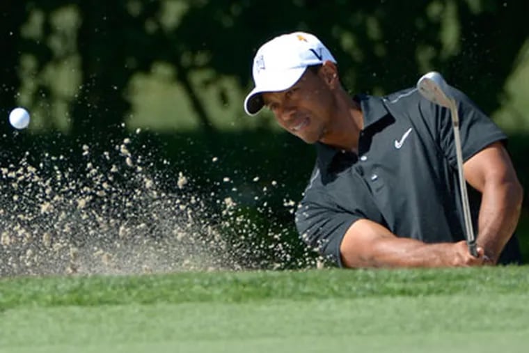 Tiger Woods hits out of a bunker during the first round of the Arnold Palmer Invitational. (Phelan M. Ebenhack/AP)