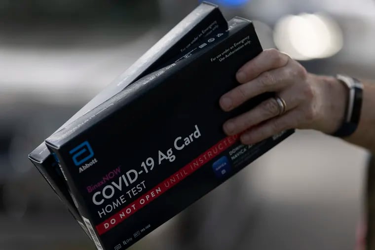COVID-19 at-home rapid test kits given out during a drive-thru event in Hollywood, Fla., on Dec. 30, 2021.