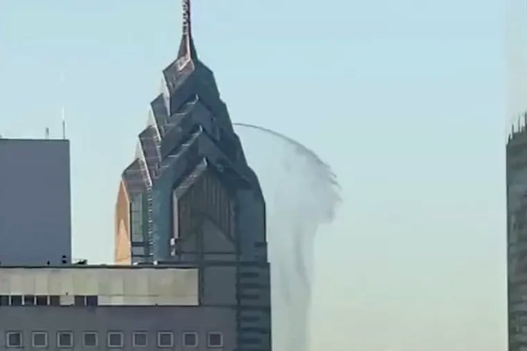 In this image taken from video water gushes out from the side of One Liberty Place on Sunday. An onlooker who took the video said the water continued coming out of the Philadelphia skyscraper for about five minutes before coming to an abrupt halt. (WHYY'S BILLY PENN, @THEPHILLYBERNEDOODLE via AP)