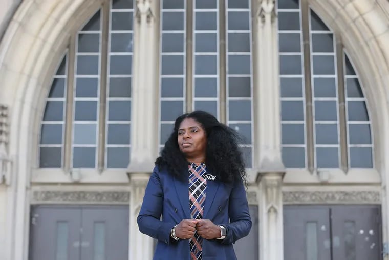 Dr. Kahlila Lee, principal of Overbrook High School, poses for a portrait outside the school. Lee says her school budget does not stretch to fill all the positions her students need. She's losing nearly four teaching positions and an assistant principal next year.
