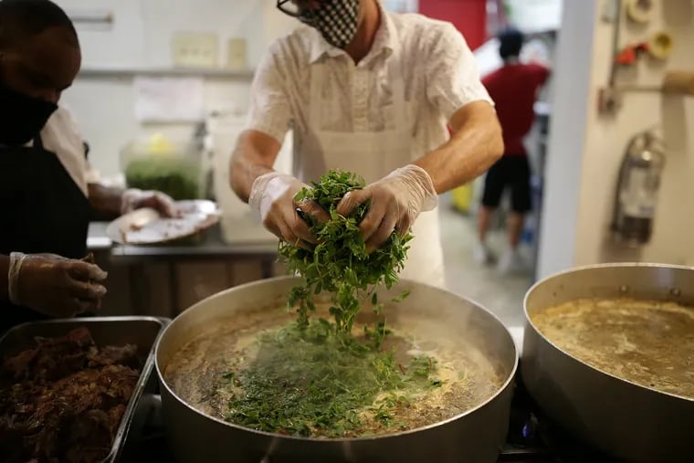 Chef Benjamin added the purslane to the verde sauce as the group at El Compadres Peoples' Kitchen prepared to make 200 meals for the needy in Philadelphia, Pa. on July 15.
