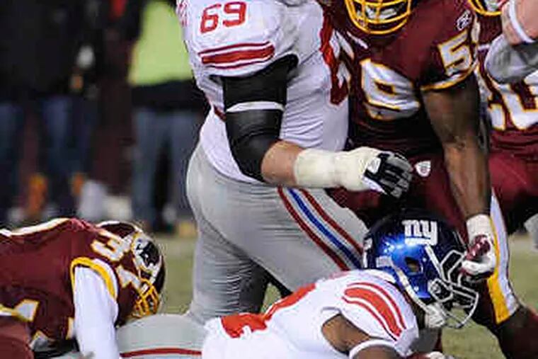 Giants' Ahmad Bradshaw battles his way across goal line in first quarter of last night's game, which ended too late for this edition. For the result, go to philly.com.