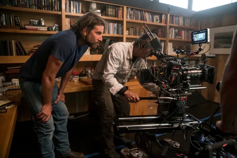 Director/co-writer/producer Bradley Cooper (left) and camera operator Scott Sakamoto on the set of "A Star is Born." Cooper was not nominated for an Oscar for best director for his work on the film.