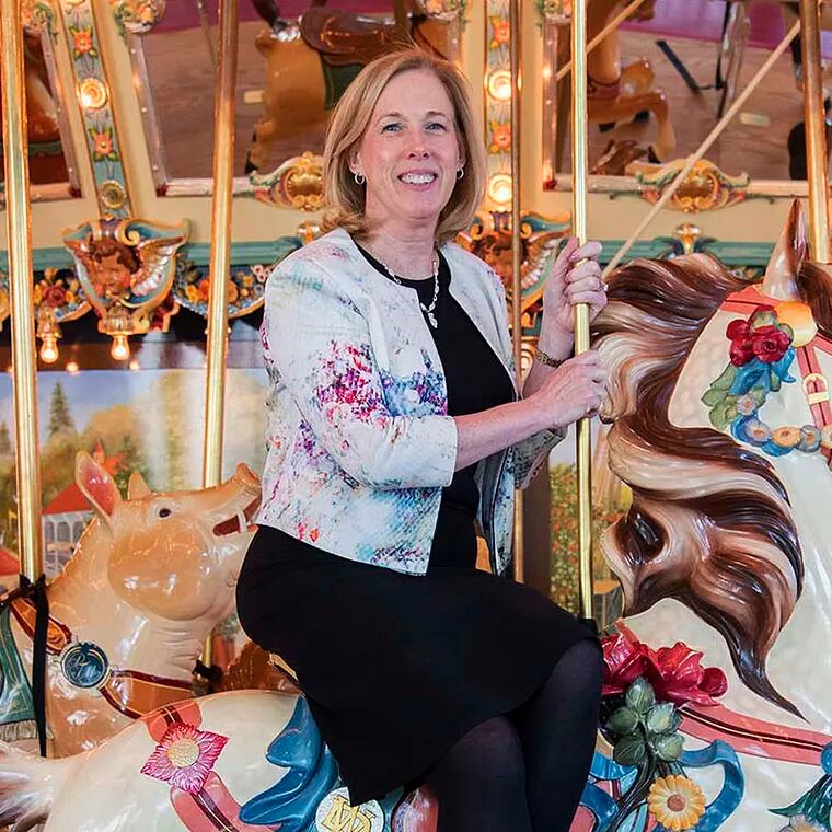 Please Touch Museum president and CEO Patricia Wellenbach on the carousel.