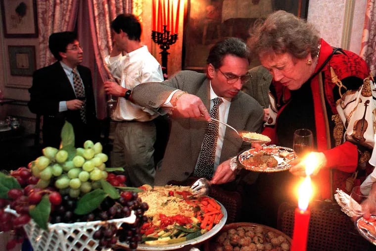 Chef Georges Perrier serving couscous to culinary doyenne Julia Child at a private party at the Rittenhouse Square home of Esther McManus on April 27, 1996.