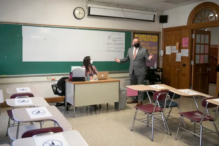 U.S. Education Secretary Miguel Cardona walks into teacher Danielle Shalon's nearly empty classroom at Beverly Hills Middle School in Upper Darby in April 2021. School lockdowns failed the students who could least afford it, writes Kyle Sammin.