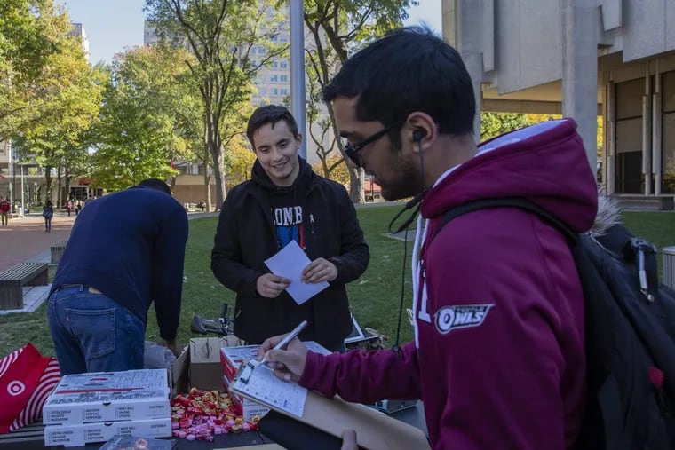 Sebastian Avila, center, encourages students to pledge to vote on Election Day next Tuesday at Temple University on Tuesday, Oct. 30, 2018. The goal was to ensure a massive young voter turnout next week.