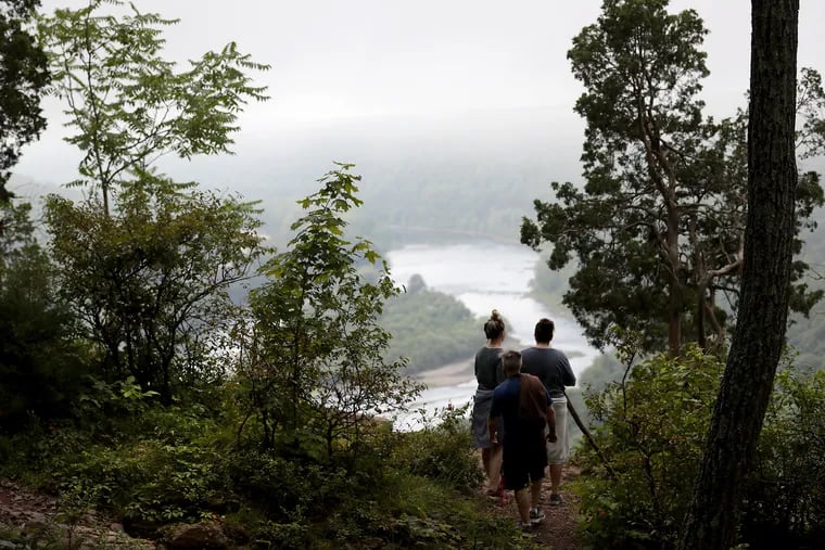 Ashtyn Stang (from left), Jake Richey and Jennene Stang stopping to look out at the Delaware Water Gap from Mount Tammany in Knowlton Township, N.J., on Aug. 2, 2019.