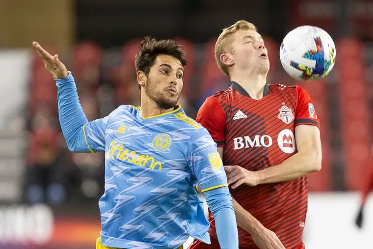 Julián Carranza (left), who scored the Union's goal, battles for the ball against Toronto FC's Jacob Shaffelburg during the first half.