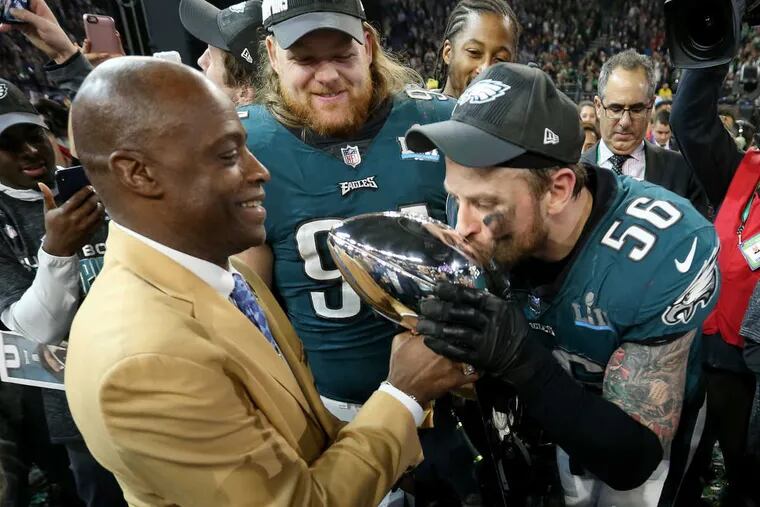 Eagles defensive end Chris Long kisses the Lombardi trophy after Super Bowl LII, at U.S. Bank Stadium in Minneapolis, Minnesota, Sunday, Feb. 4, 2018.