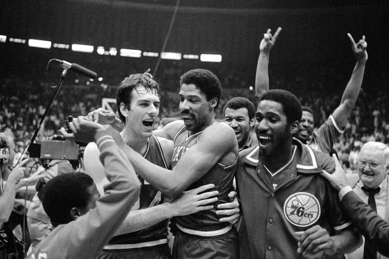 Bobby Jones (left) embraces Julius Erving after the Philadelphia 76ers defeated the Los Angeles Lakers in four straight games to win the 1983 NBA Championship. Jones this year will join his former teammate in the Basketball Hall of Fame.