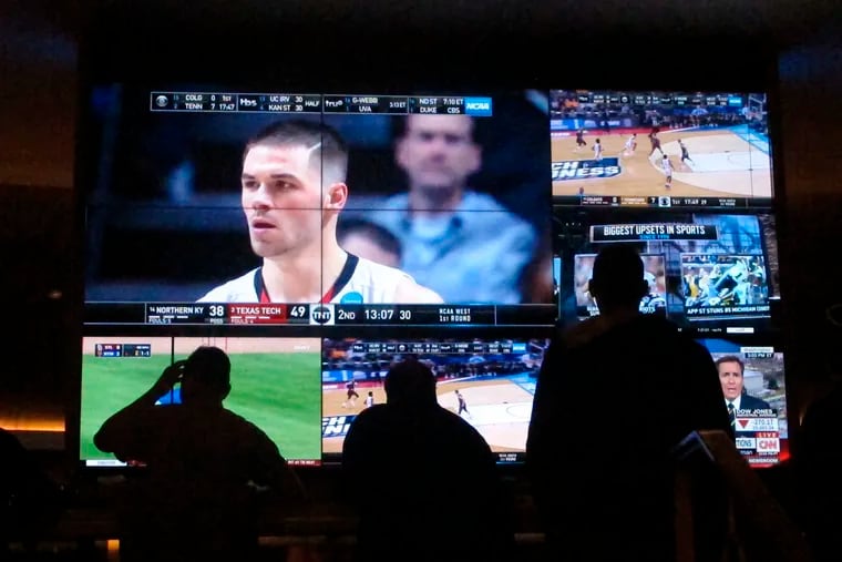 Customers watch NCAA March Madness games at the Hard Rock Casino's sportsbook in Atlantic City. In-person sports betting is expanding in New Jersey and other states.