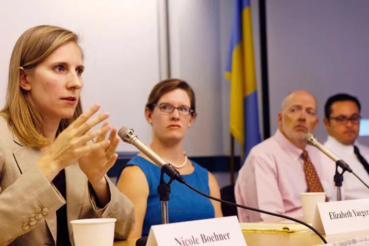 Nicole Boehner with the office of the U.N. High Commissioner for Refugees speaks. Other panel members included (from left) Elizabeth Yaeger, Peter Gottemoller, Steven Larin.