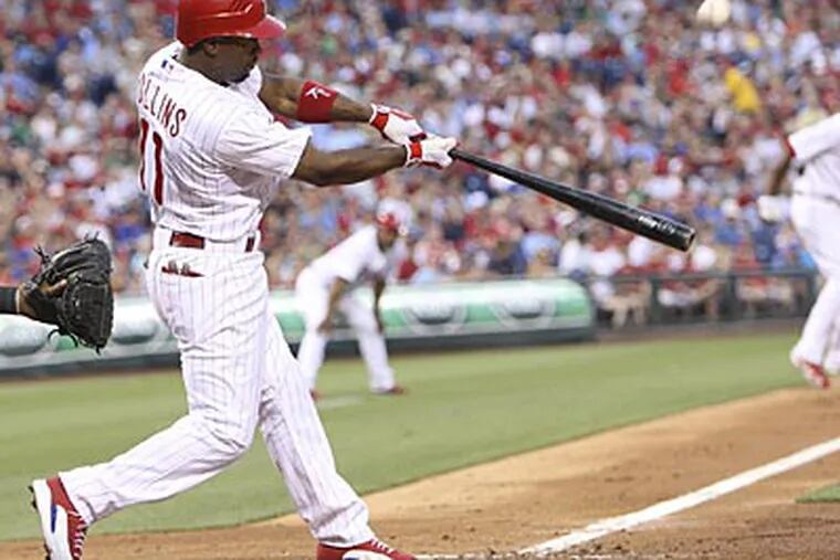 Jimmy Rollins drives in a run in the fourth inning against the Rockies on Wednesday. (Steven M. Falk/Staff Photographer)