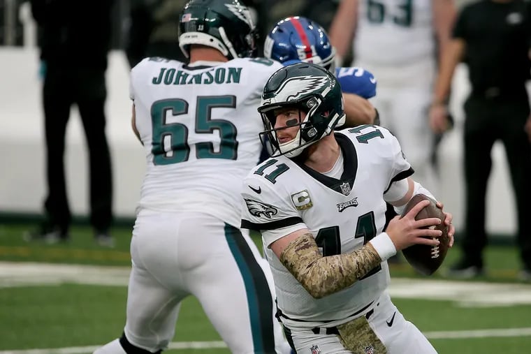 Eagles quarterback Carson Wentz spins away from the defensive pressure in the second quarter against the Giants.The Philadelphia Eagles play the New York Giants at MetLife Stadium in East Rutherford, N.J. on November 15, 2020.