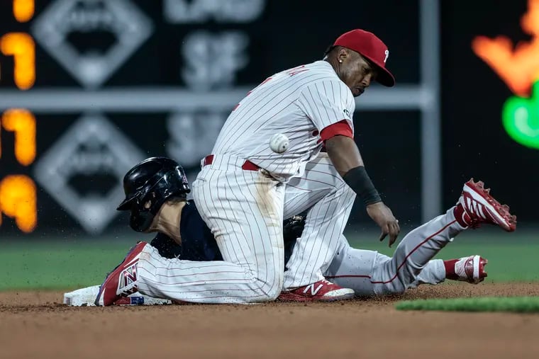 Phillies second baseman Jean Segura drops the ball as Boston's Enrique Hernandez steals second base during the seventh inning Friday night at Citizens Bank Park.