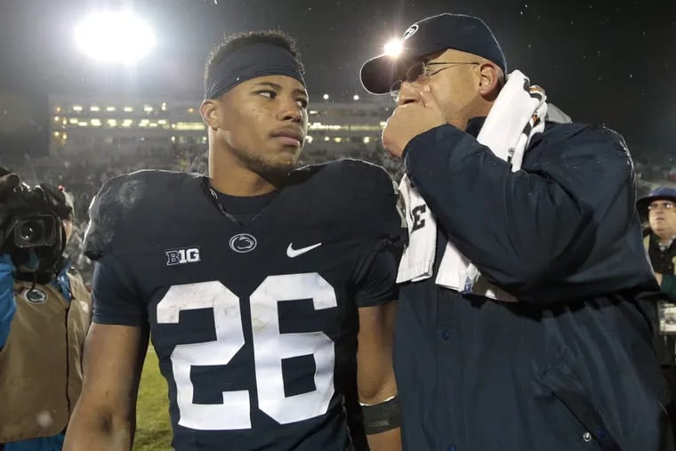 Saquon Barkley (26) walks off the field with coach James Franklin after the victory over Nebraka.