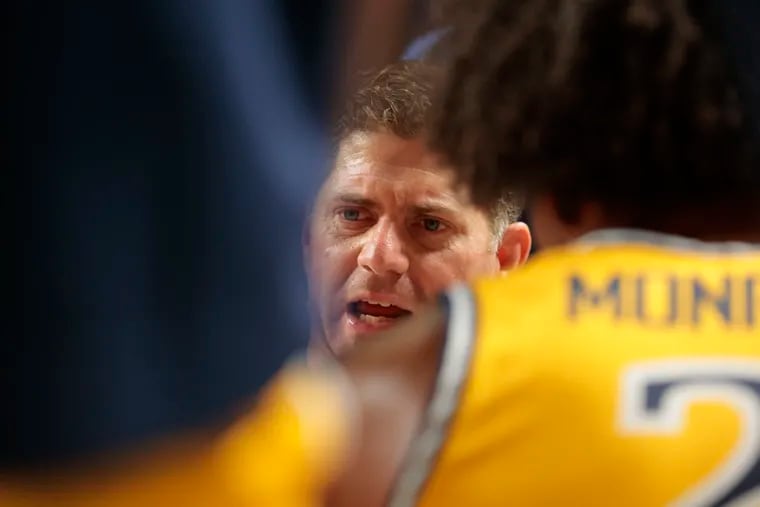 Drexel coach Zach Spiker huddles his team during the Dragons' game against Temple in November.