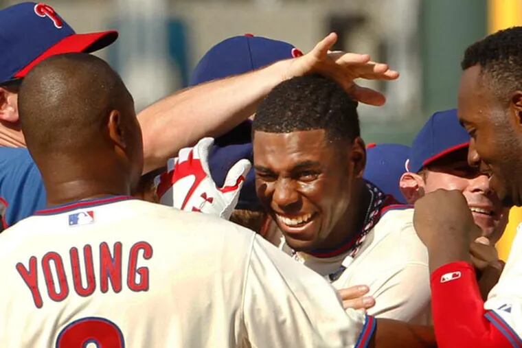 John Mayberry Jr. is swarmed by teammates after driving in the winning run to give the Phillies a 4-3 win over the Chicago White Sox. (Ron Cortes/Staff Photographer)