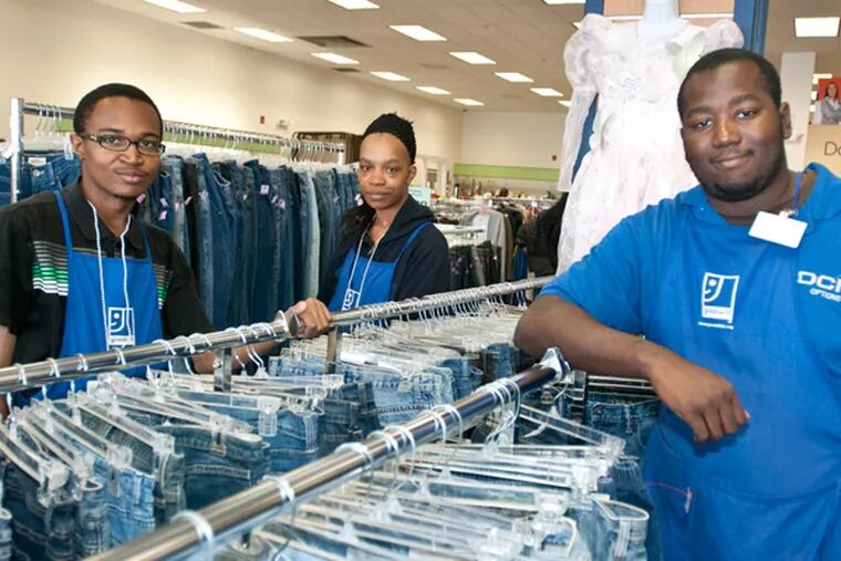 From left Andre Brooks, Whitney Williams, and Joseph Opont, all students from Upper Darby School District who aged out of special education at 21 and are now taking part in a pilot program by Goodwill to train them to work in its retail store in Lansdowne. (RON TARVER/Staff Photographer)