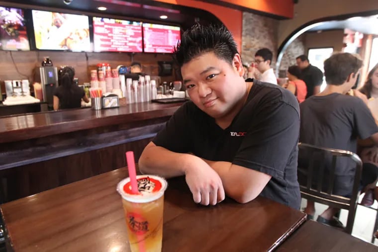 Owner Kenny Poon, with a Hong Jasmine Bubble tea drink,  at his hip tea shop, Tea Do, on the northwest corner of 10th and Cherry Streets in Chinatown.    8/29/ 2013 ( MICHAEL BRYANT / Staff Photographer )