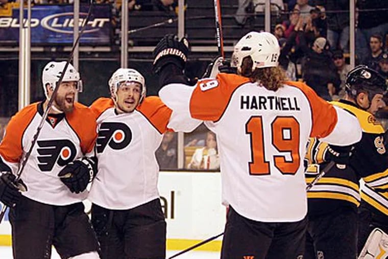 Scott Hartnell celebrates his goal with Ville Leino and Danny Briere. (Yong Kim / Staff Photographer)
