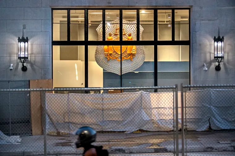 July 12, 2021: A newly installed oversized police badge is visible in the lobby of the former Inquirer and Daily News Building on North Broad Street. The 18-story Beaux-Arts-style skyscraper is being renovated to become the new headquarters of the Philadelphia Police Department. The newspapers and Inquirer.com moved into offices in the former Strawbridge & Clothier department store at Eighth and Market Streets nine years ago last week.