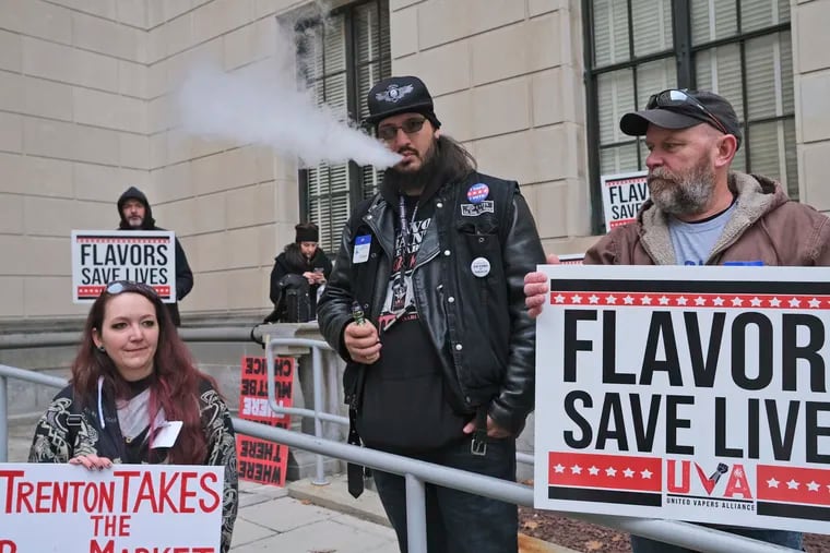 Matthew Elliot, center, and other supporters of flavored vaping products protest at the state house in Trenton, N.J.