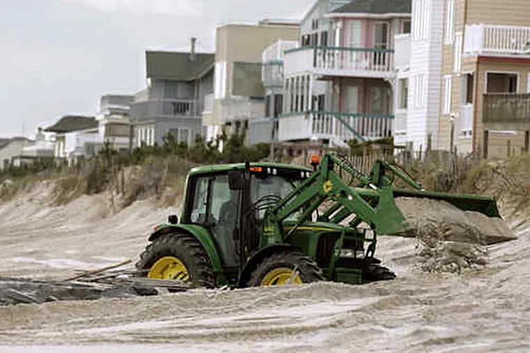 A tractor moves sand in Harvey Cedars in this file photo. Mike Derer/Associated Press