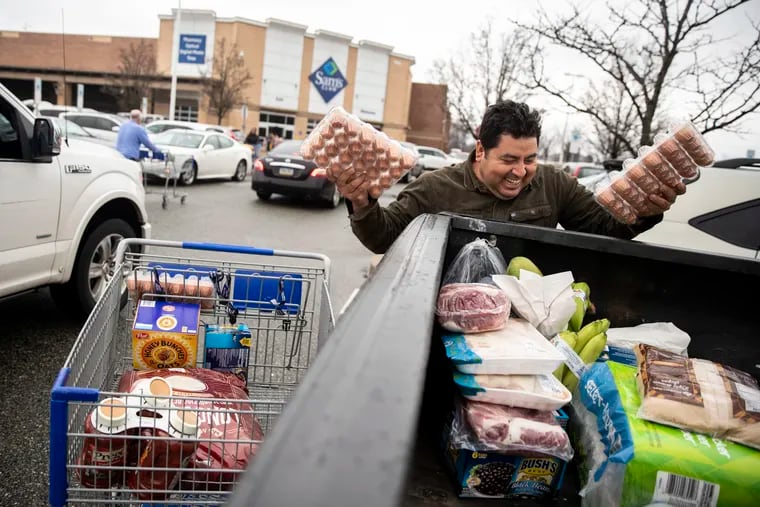 Daniel Mendoza, of Willow Grove, puts food in his truck at the Sam's Club in Willow Grove, Pa. on Friday, March 13, 2020. Mendoza said he's doing extra shopping in case the stores close at some point, because of the coronavirus. All Montgomery County schools, community centers, gyms and entertainment venues will be shut down for two weeks.