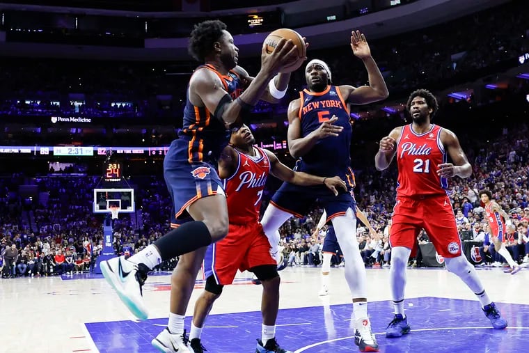 New York Knicks forward OG Anunoby grabs a offensive rebound with teammate forward Precious Achiuwa past Sixers guard Kyle Lowry and center Joel Embiid during the fourth quarter in Game 4 of the first round NBA Eastern Conference playoffs on Sunday, April 28, 2024 in Philadelphia.