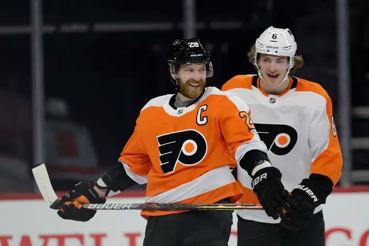 Claude Giroux, (left) shown here sharing a smile with Travis Sanheim during Sunday's intrasquad game, is going into his ninth season as Flyers captain.