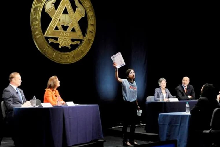 From left, State treasurer Rob McCord, former state environmental protection secretary Katie McGinty, U.S. Rep. Allyson Schwartz and businessman Tom Wolf look on as an unidentified woman, center, interrupts the Pennsylvania Democratic Gubernatorial Primary Debate on Monday, May 12, 2014, in Philadelphia.