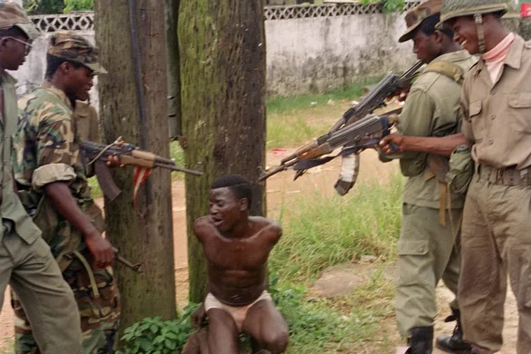 Starting Monday, Mohammed Jabateh, a 50-year-old Delaware County man, will face a federal trial on allegations he lied about his war crimes he allegedly committed during  Liberia’s bloody civil wars. In this 1992 file photo, members of ULIMO, the militia of which Jabateh was a member, tease a suspected rival soldier with a mock execution on the outskirts of Monrovia, Liberia.
