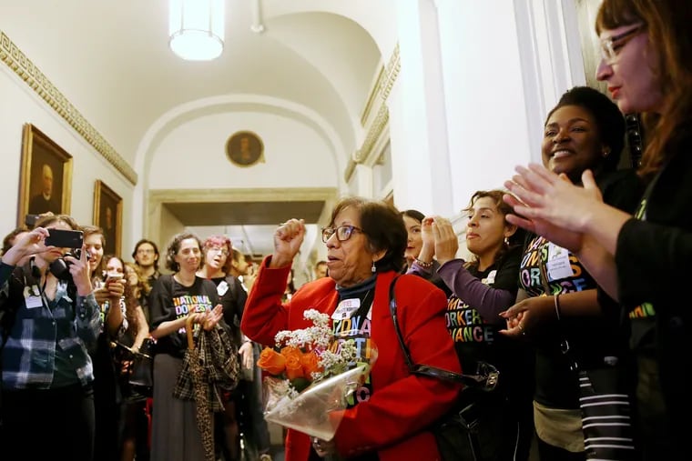 Mercedes Reyes (center), a live-in domestic worker and leader within the Pennsylvania Domestic Workers Alliance, cheers after City Council passed a bill expanding labor protections for domestic workers on Oct. 31, 2019.