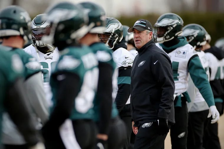 Eagles head coach Doug Pederson watching as players warm up during practice at the NovaCare Complex in South Philadelphia on Dec. 7.
