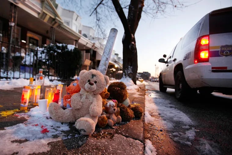 A memorial marks the spot of a homicide in the 6800 block of Smedley Street. Police have increased their presence in problem neighborhoods. At the current pace, Philadelphia is on track for the lowest homicide total in 45 years, Dec. 11, 2013. (MICHAEL S. WIRTZ/Staff Photographer)