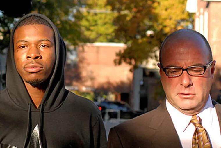 Lemuel Payne, left, walks into Delaware Co. Courthouse with attorney Mark
Much, right, to surrender on charges he struck and killed 16-year-old
Faith Sinclair. (Tom Gralish / Inquirer)